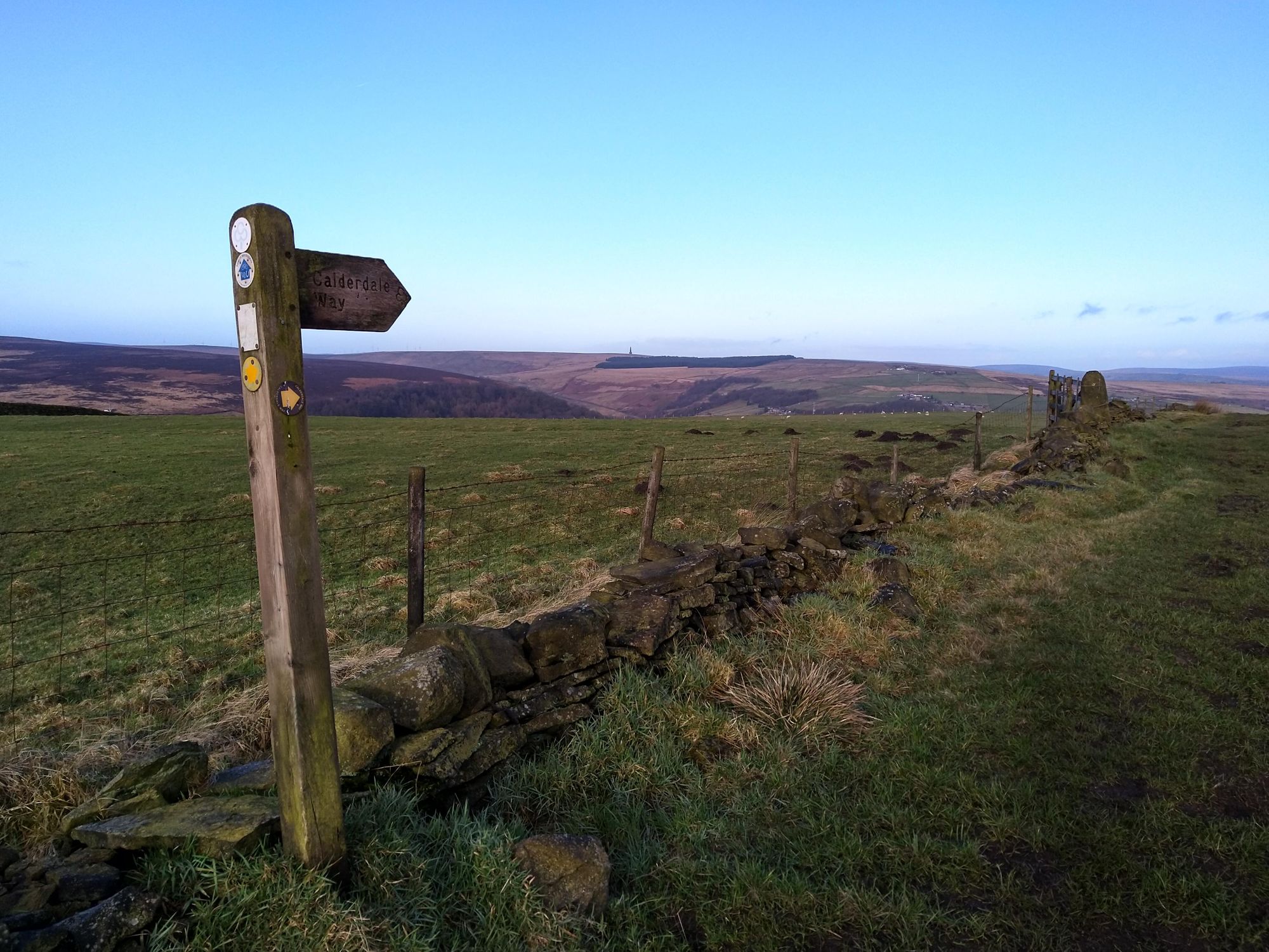 Calderdale Way footpath sign with Stoodley Pike monument in the distance